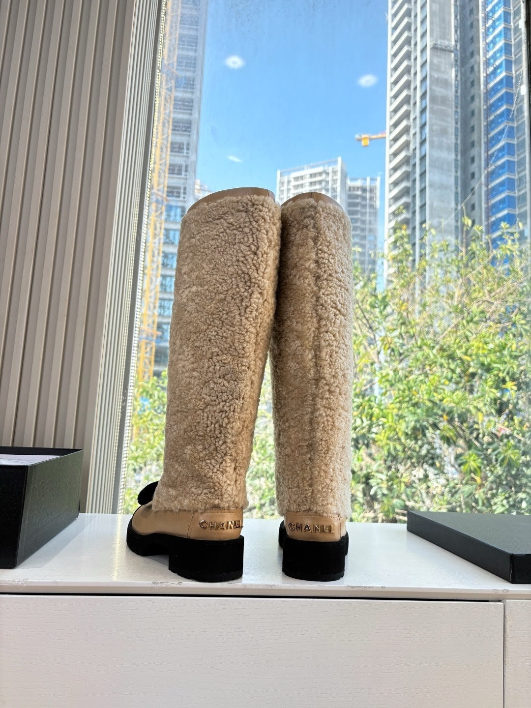 KNEE-HIGH SHEARLING BOOTS WITH PATENT CAP TOE AND BOW DETAIL