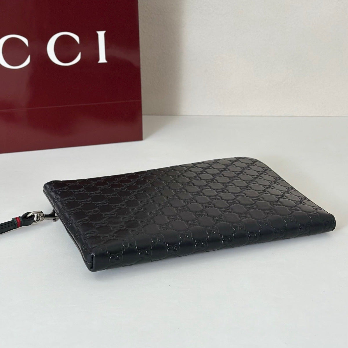 EMBOSSED LEATHER WRISTLET CLUTCH