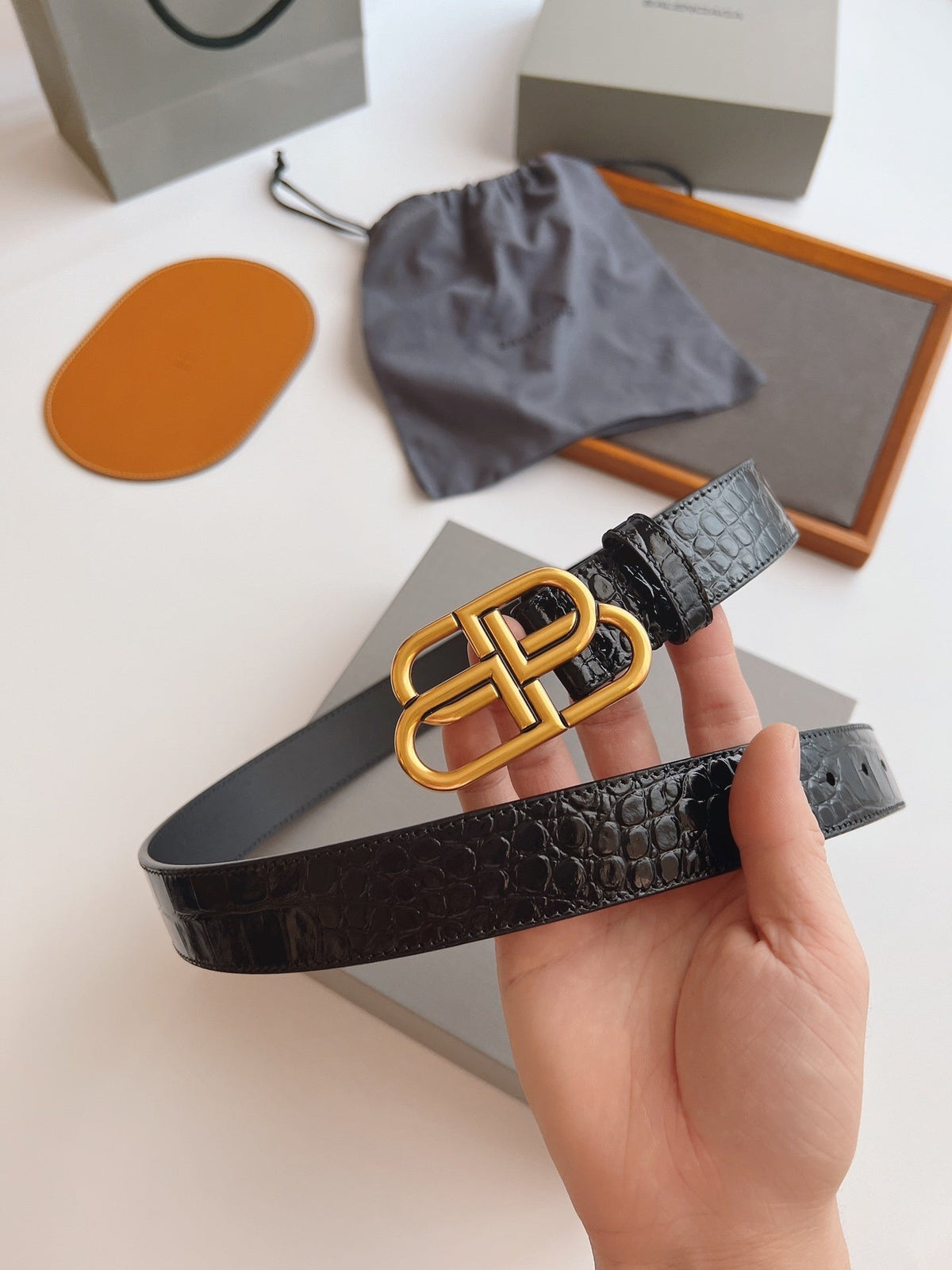 EMBOSSED BLACK LEATHER BELT WITH GOLD-TONE LOGO BUCKLE