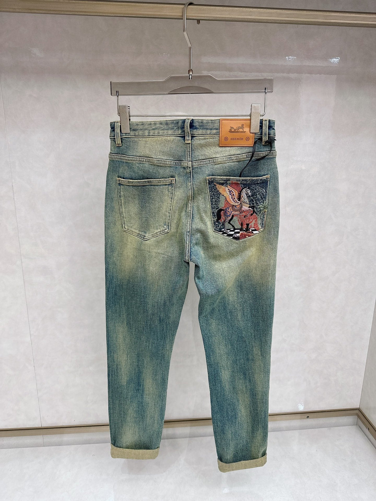 DISTRESSED DENIM JEANS WITH GRAPHIC BACK POCKET