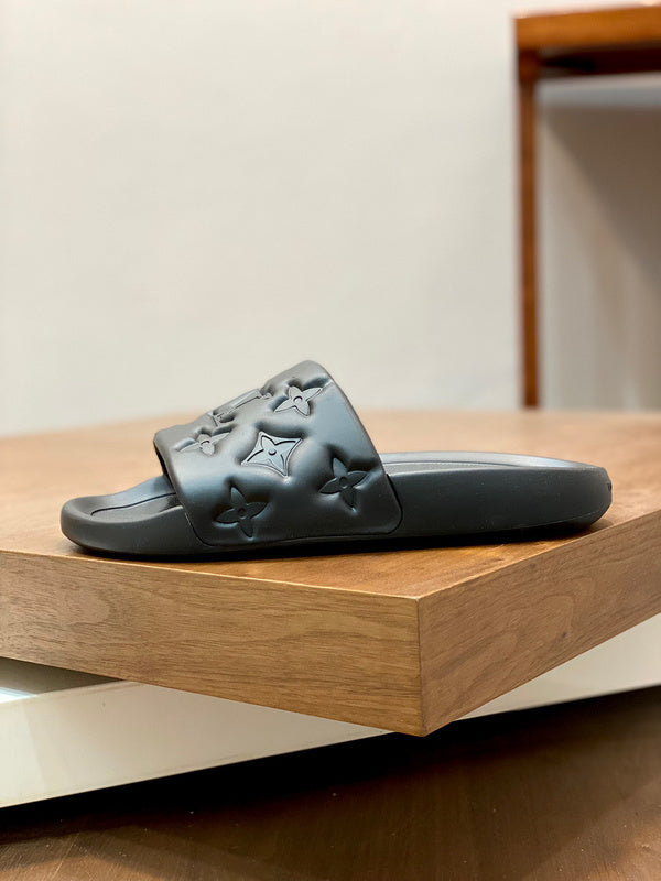 BLACK EMBOSSED MONOGRAM RUBBER SLIDE SANDALS