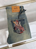 DISTRESSED DENIM JEANS WITH GRAPHIC BACK POCKET