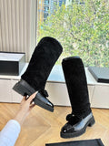 KNEE-HIGH SHEARLING BOOTS WITH PATENT CAP TOE AND BOW DETAIL